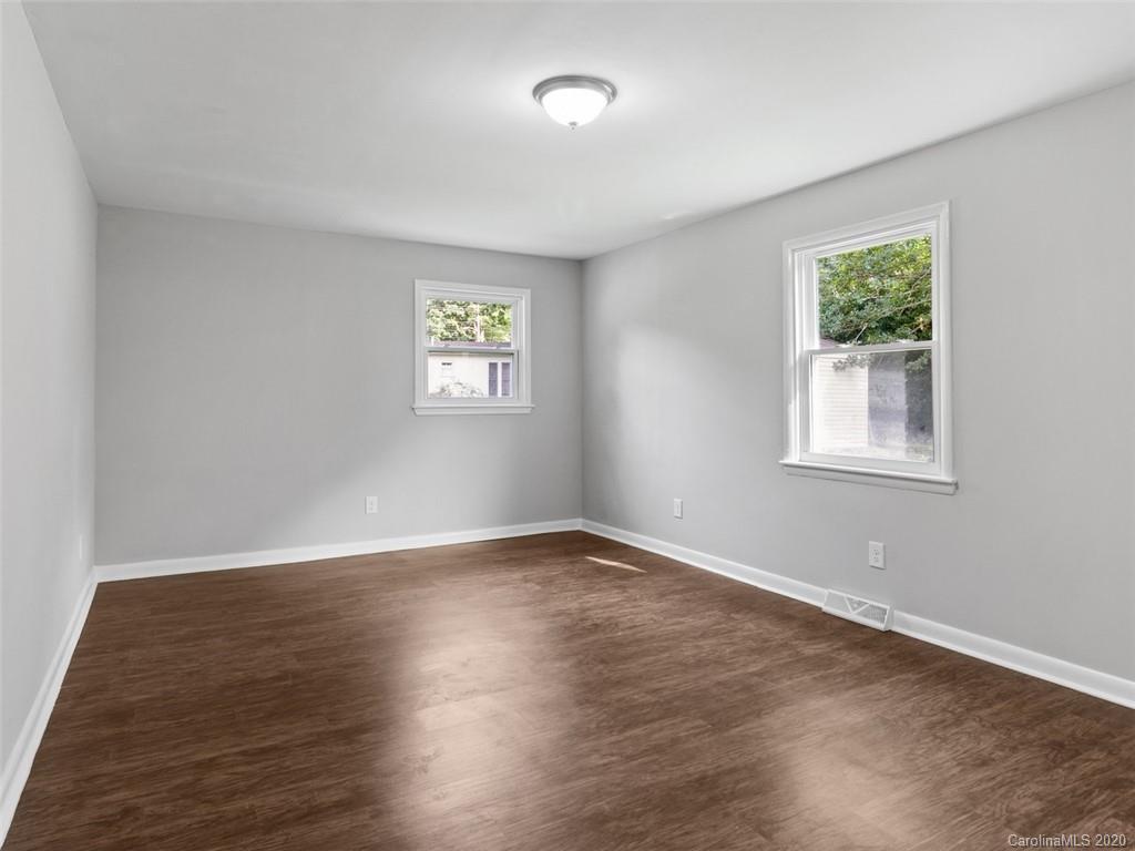 1609 Scott Road Statesville, NC 28625 - Photo 26 of 35 a view of an empty room with wooden floor and a window
