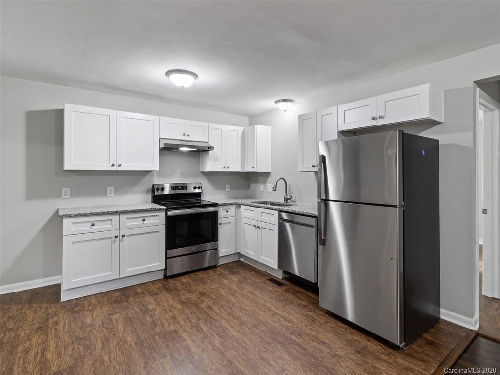 1609 Scott Road Statesville, NC 28625 - Photo 4 of 35 a kitchen with a refrigerator and a stove top oven