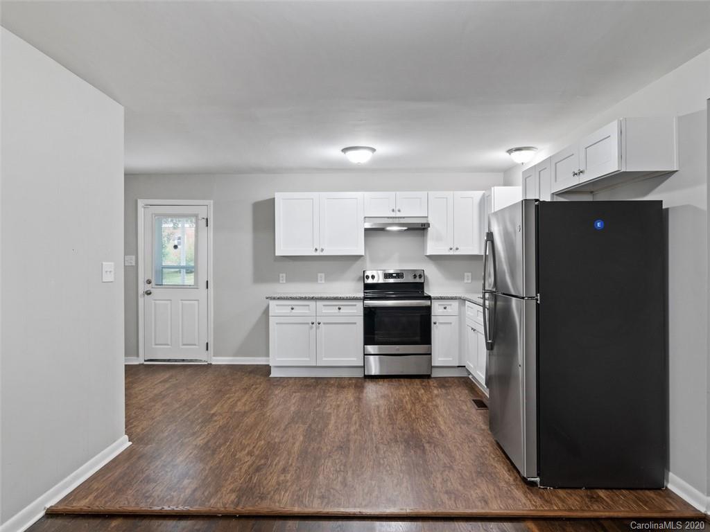 1609 Scott Road Statesville, NC 28625 - Photo 5 of 35 a kitchen with granite countertop a refrigerator and a stove