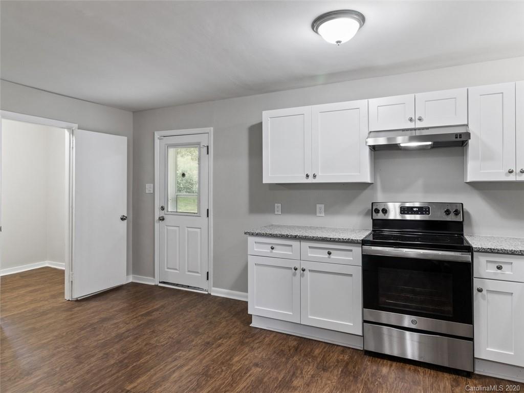 1609 Scott Road Statesville, NC 28625 - Photo 6 of 35 a kitchen with a stove and white cabinets