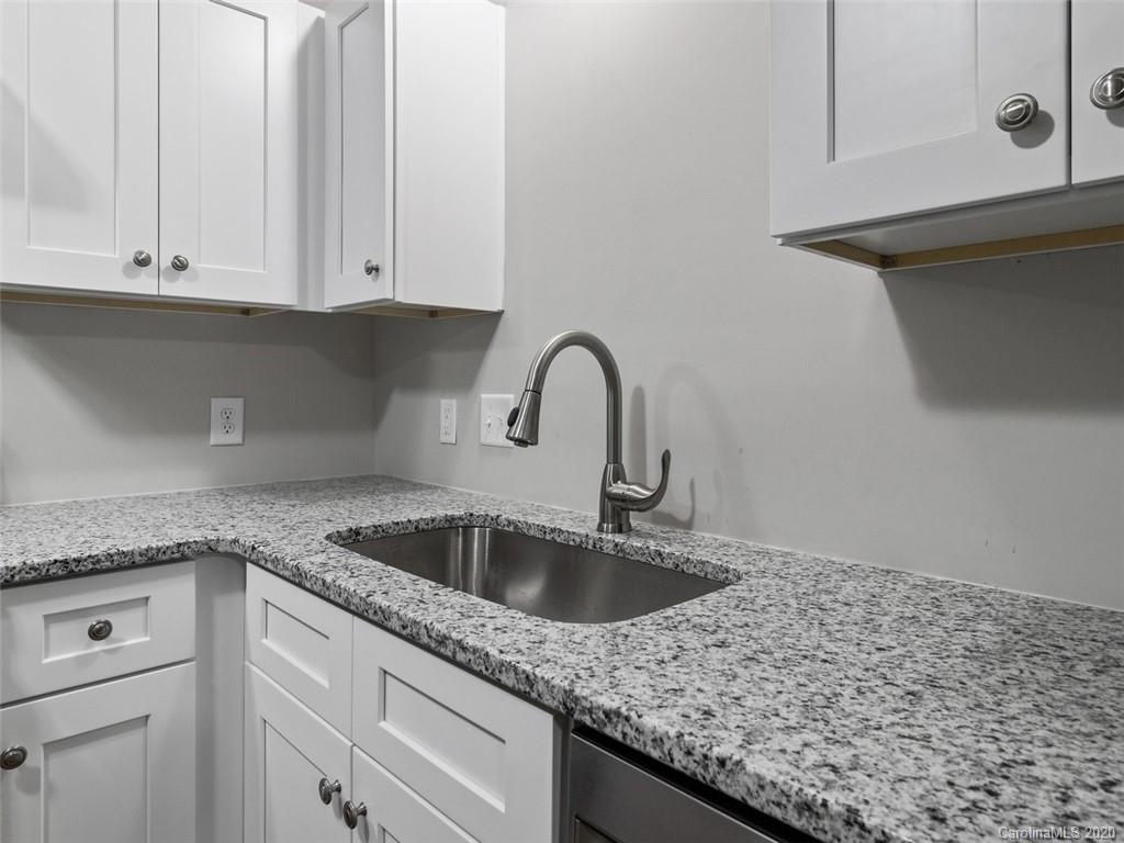 1609 Scott Road Statesville, NC 28625 - Photo 8 of 35 a kitchen with granite countertop white cabinets and sink