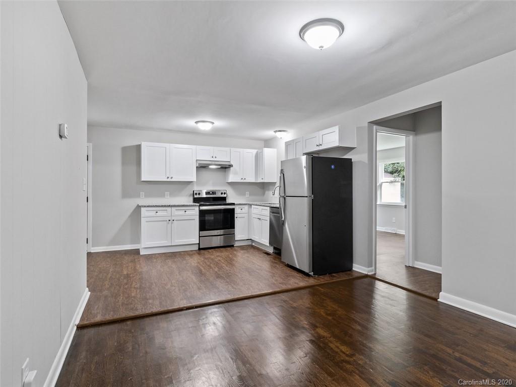1609 Scott Road Statesville, NC 28625 - Photo 10 of 35 a kitchen with a refrigerator and a stove top oven