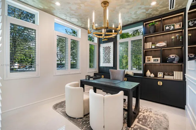 a view of a dining room with furniture and chandelier