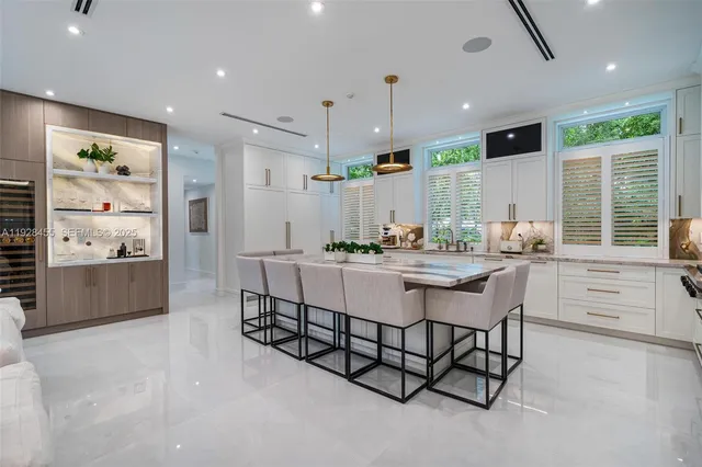 a living room with patio furniture and a flat screen tv
