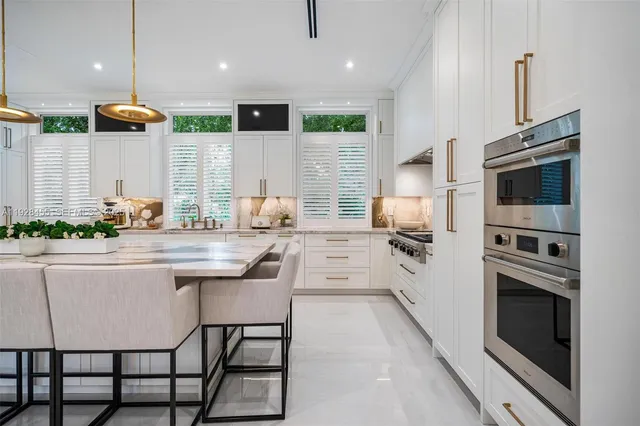 a living room with furniture a flat screen tv and a floor to ceiling window
