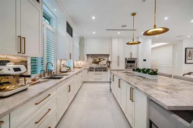 a view of a patio with table and chairs under an umbrella