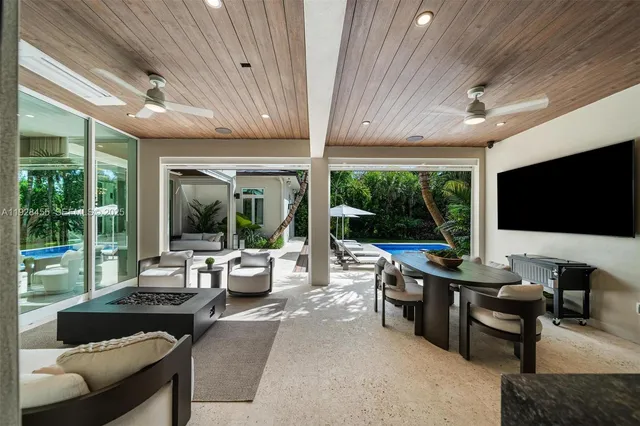 a living room with furniture ceiling fan and a potted plant