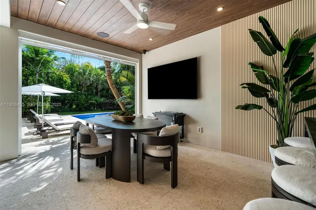 a living room with furniture a flat screen tv and a potted plant