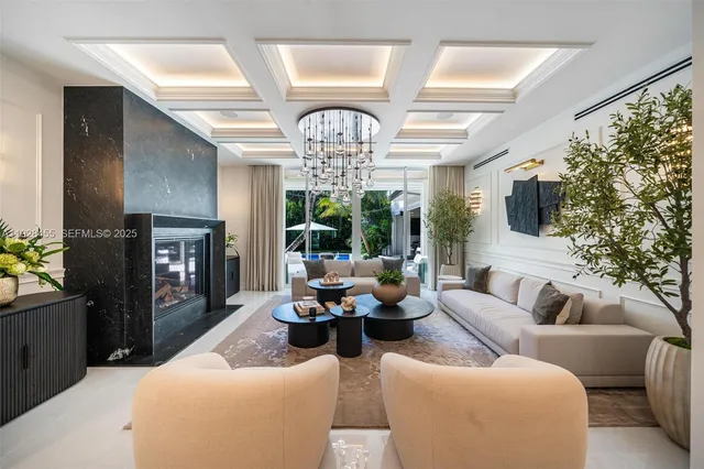 a living room with furniture a flat screen tv and a large window