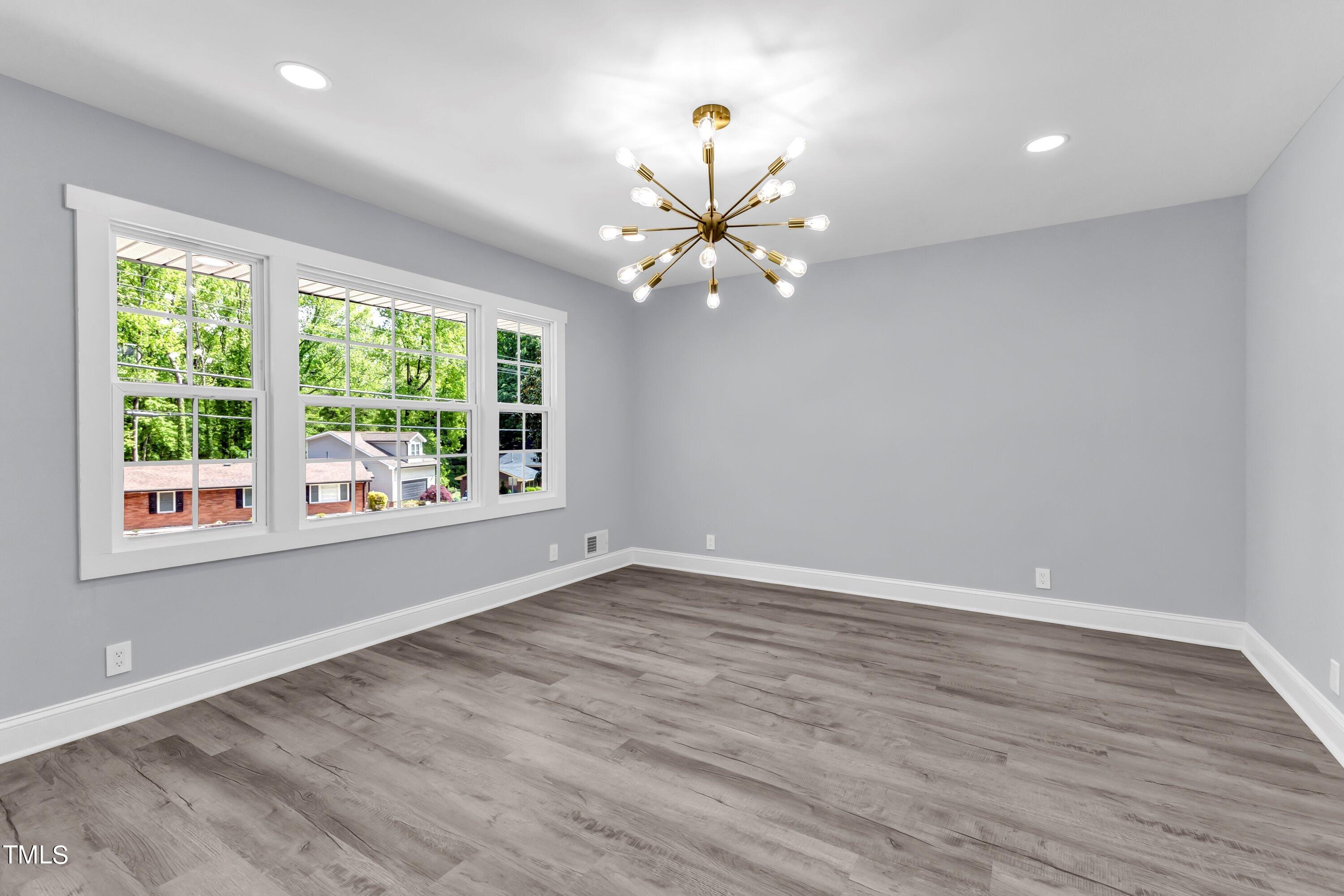 3429 Brentwood Road Raleigh, NC 27604 - Photo 4 of 54 a view of an empty room with a window