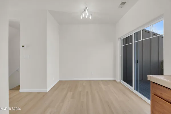 a large white kitchen with a sink a stove and a refrigerator