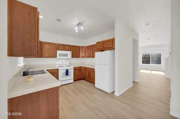 a kitchen with a sink stove and microwave