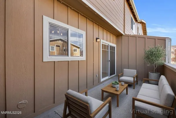 a view of a house with a wooden deck next to a yard