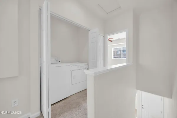 a view of an empty room with a ceiling fan