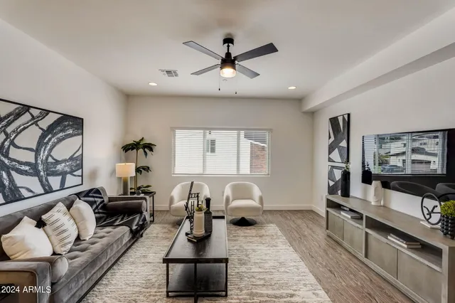 a living room with furniture a rug and a flat screen tv