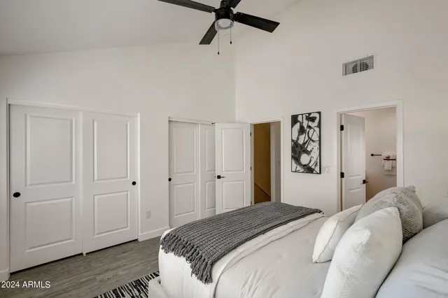 a bedroom with a bed and a chandelier