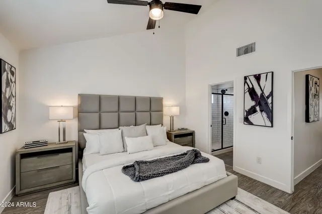 a bedroom with a bed and ceiling fan