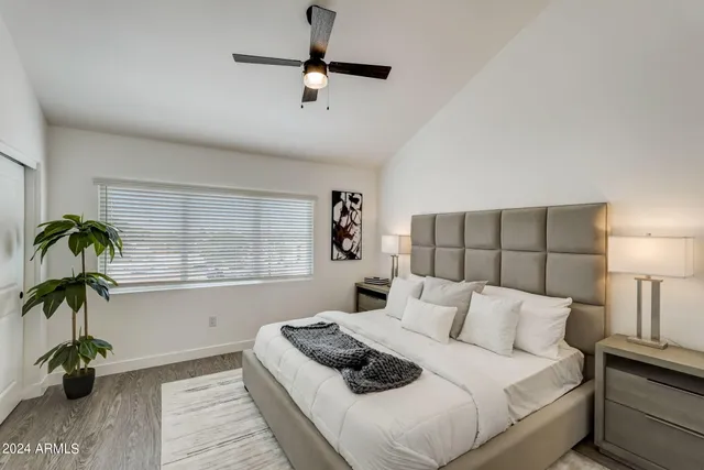 a bedroom with a bed and a potted plant