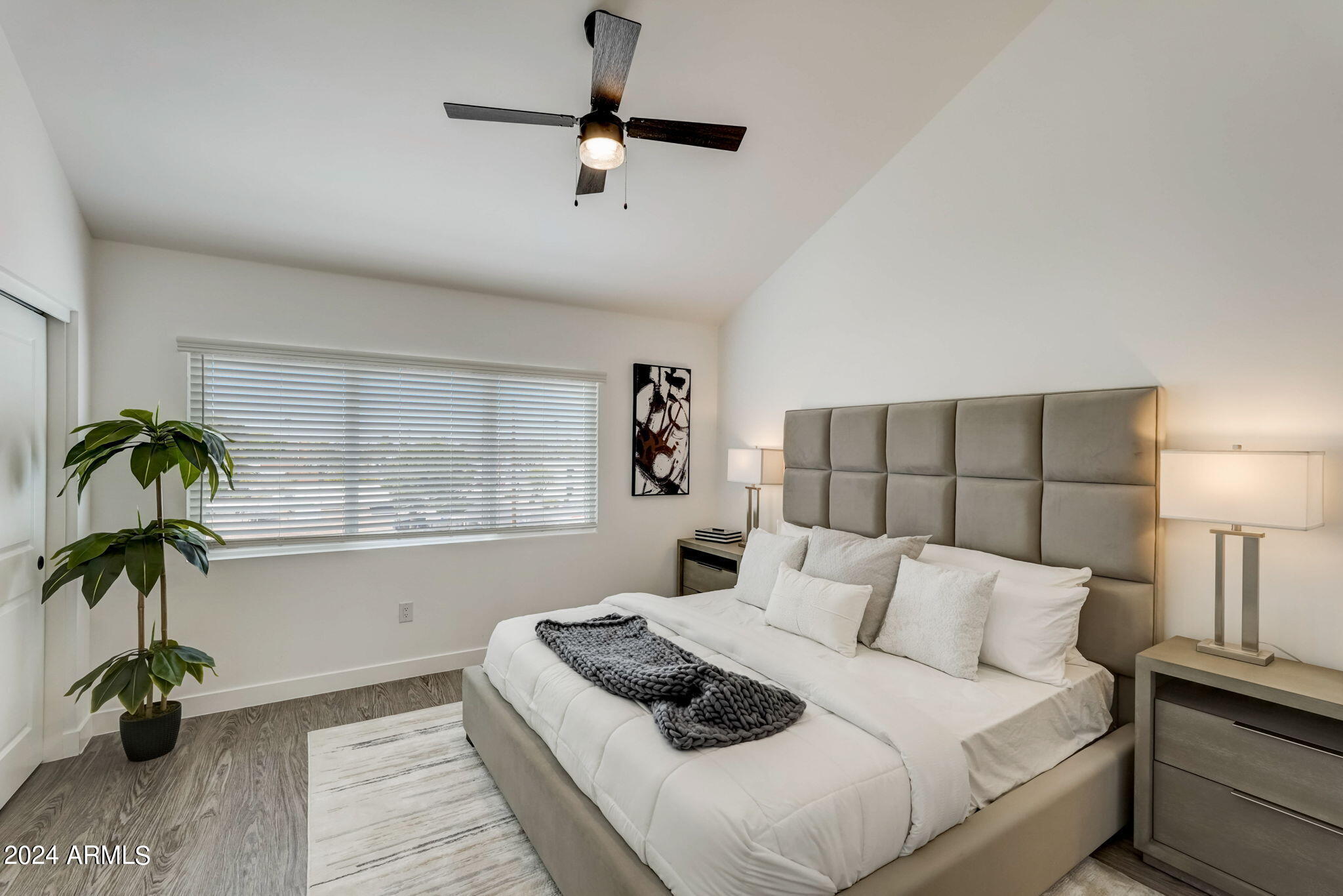 3645 East Earll Drive, Unit 15 Phoenix, AZ 85018 - Photo 16 of 27 a bedroom with a bed and a potted plant