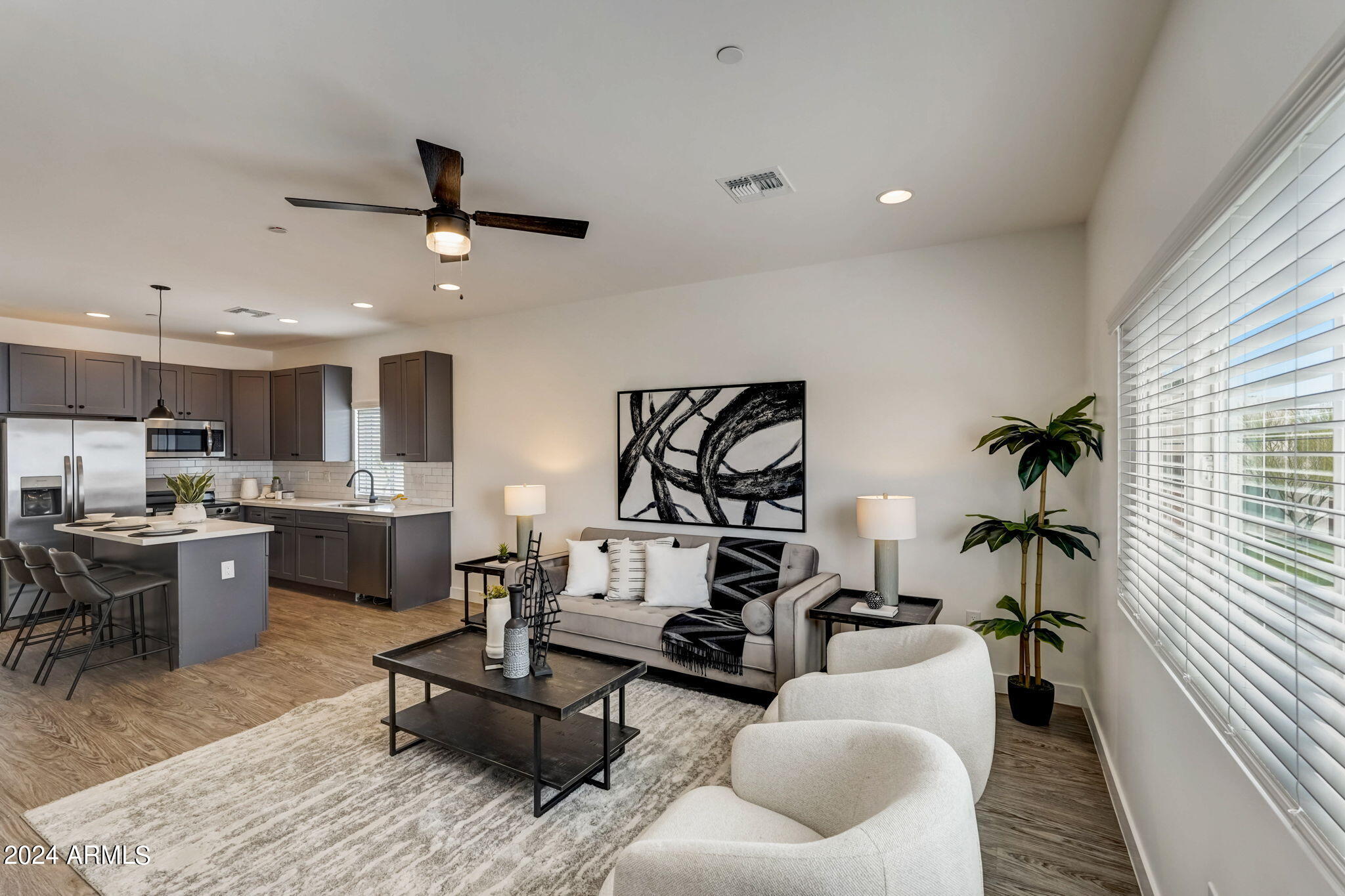 3645 East Earll Drive, Unit 15 Phoenix, AZ 85018 - Photo 3 of 27 a living room with furniture kitchen view and a window
