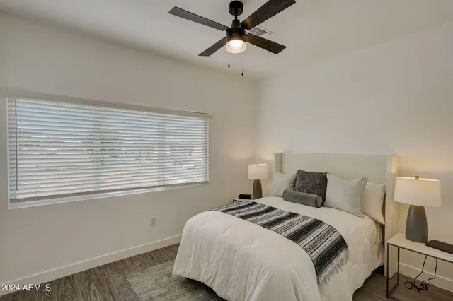 a bedroom with a bed and a window