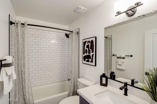a bathroom with a shower sink and toilet