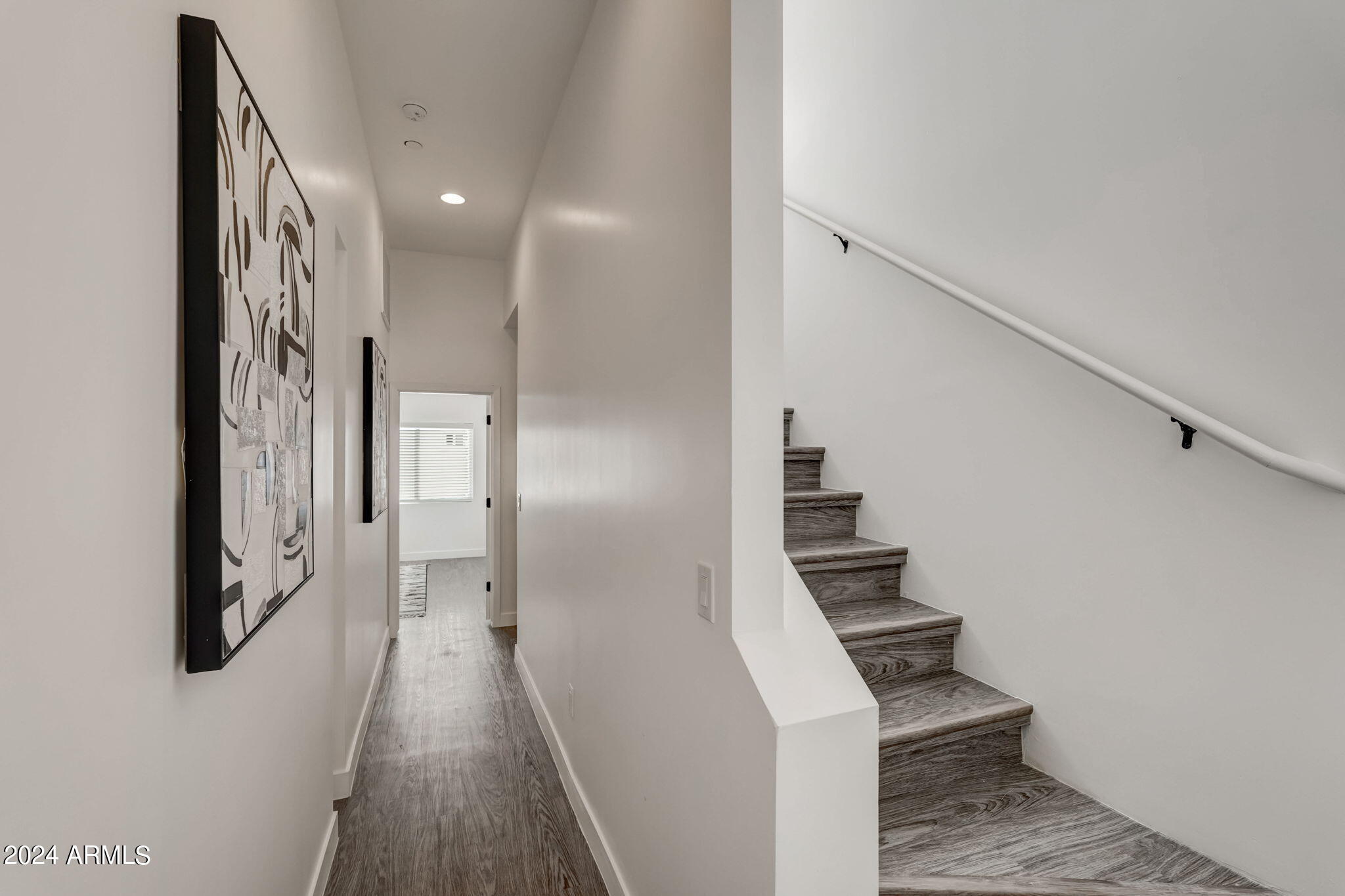3645 East Earll Drive, Unit 15 Phoenix, AZ 85018 - Photo 9 of 27 a view of hallway with stairs and wooden floor