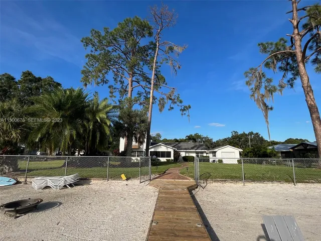 a lake view with a bench and trees around