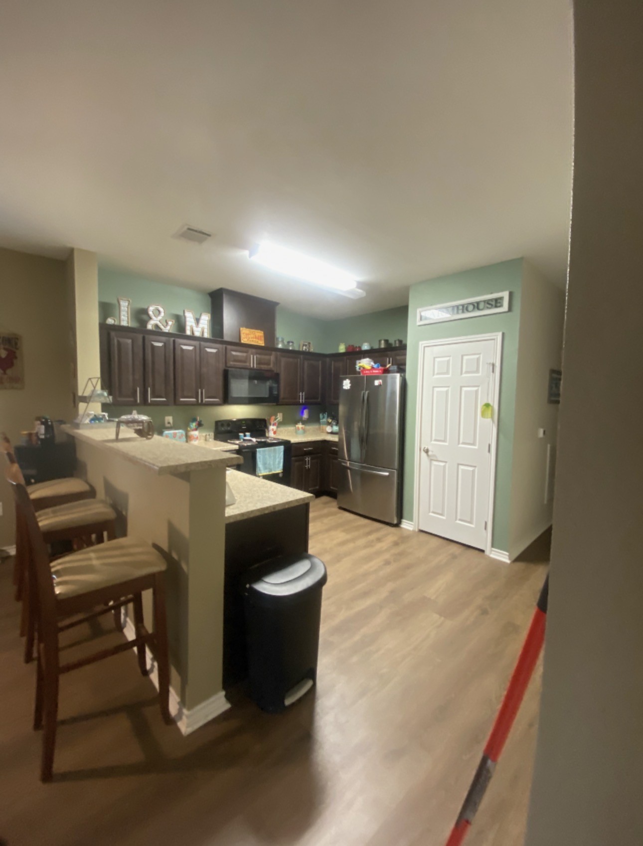 500 Warnock Glade Road Colmesneil, TX 75938 - Photo 7 of 18 a kitchen with a table chairs a refrigerator and a window