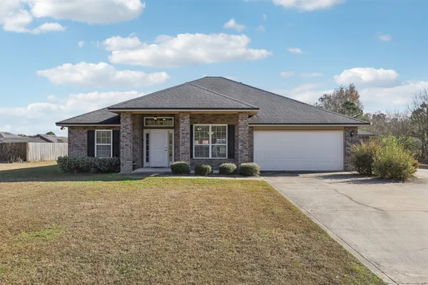 a front view of a house with yard