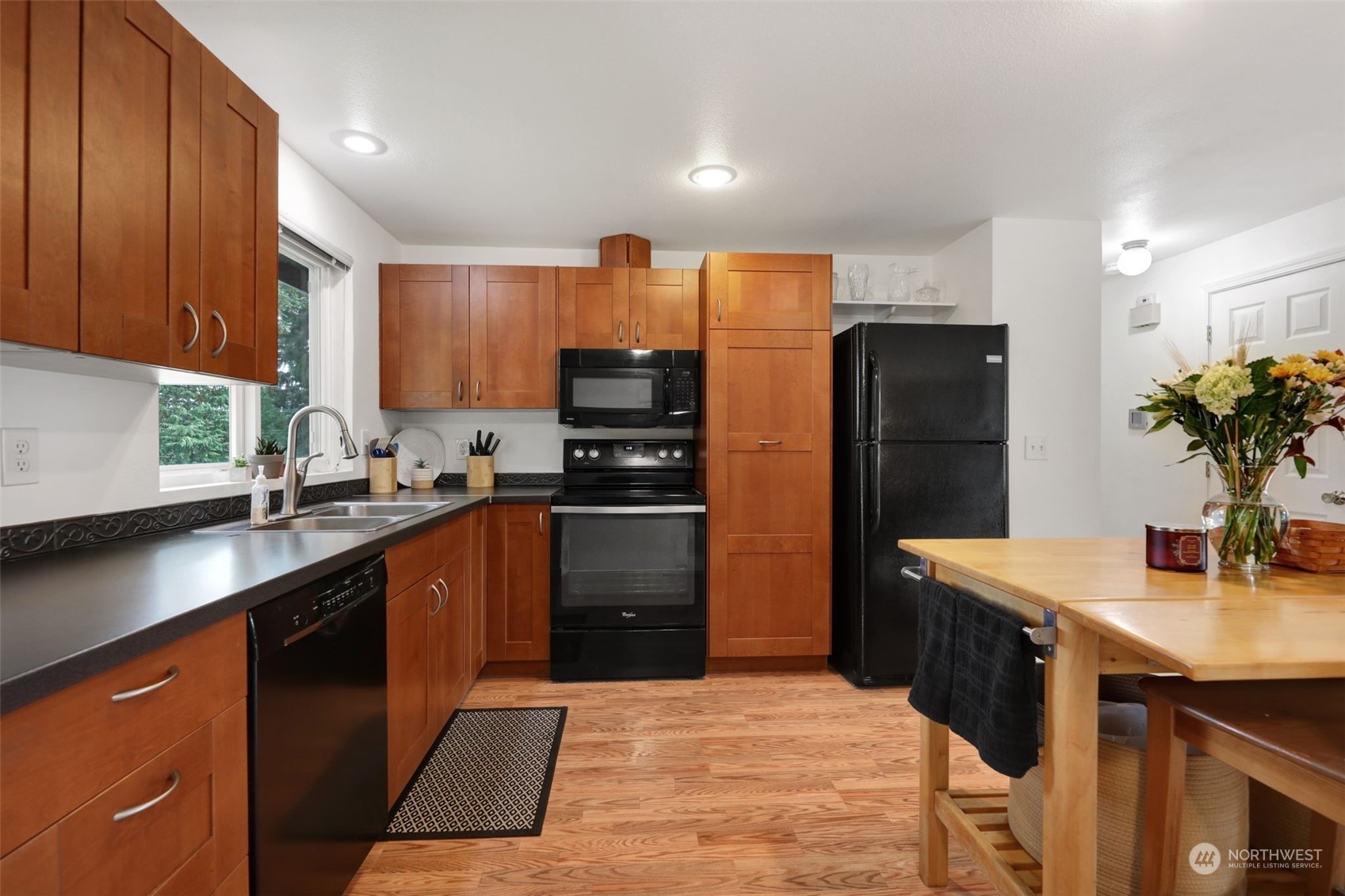 525 222nd Street Southwest Bothell, WA 98021 - Photo 9 of 25 a kitchen with stainless steel appliances kitchen island granite countertop a refrigerator a sink dishwasher and a stove with wooden cabinets