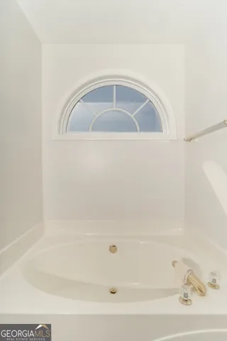 a view of walk in closet with clothes