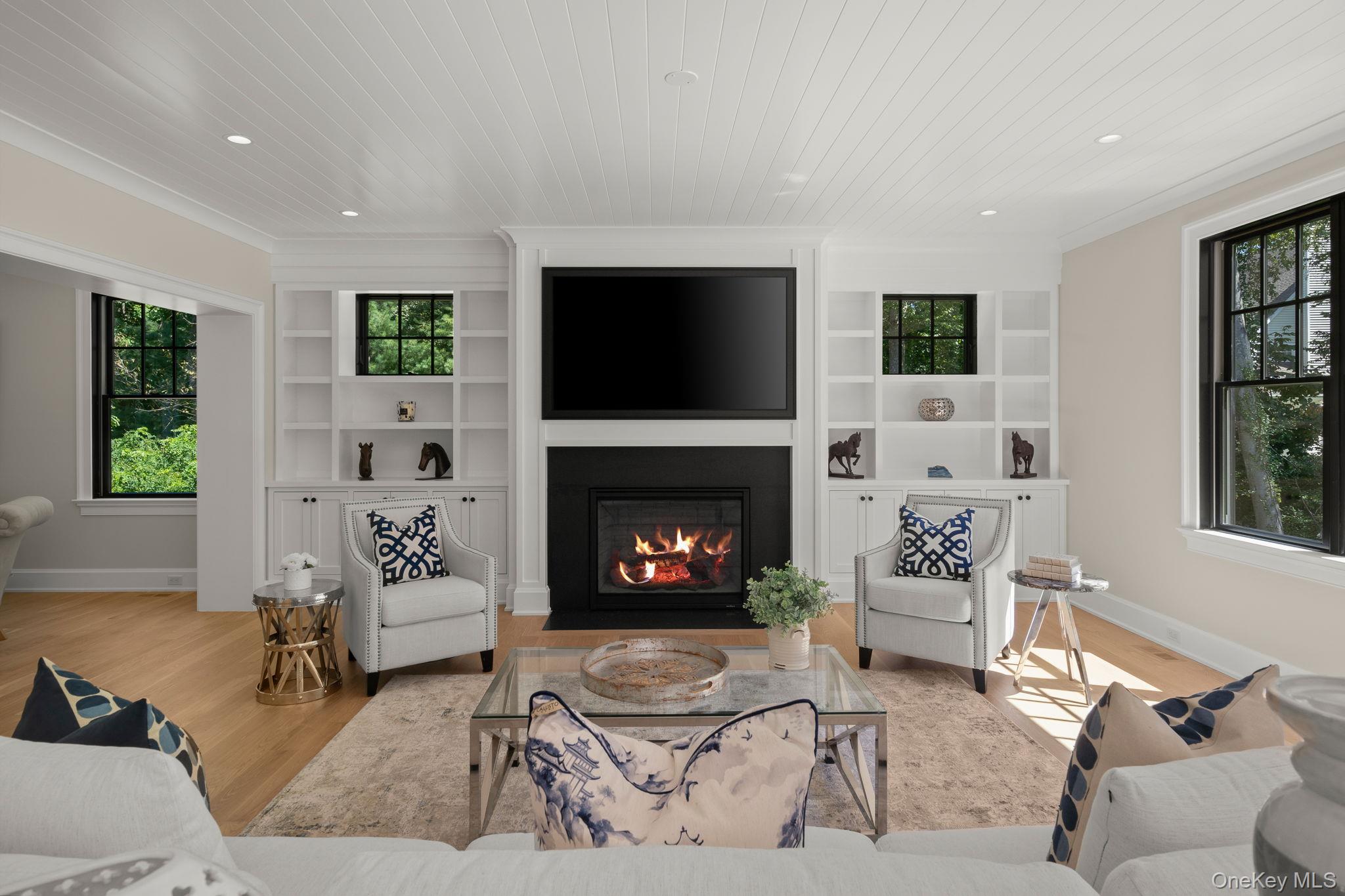 64 Saw Mill Road Cold Spring Harbor, NY 11724 - Photo 11 of 50 a living room with furniture a flat screen tv and a fireplace