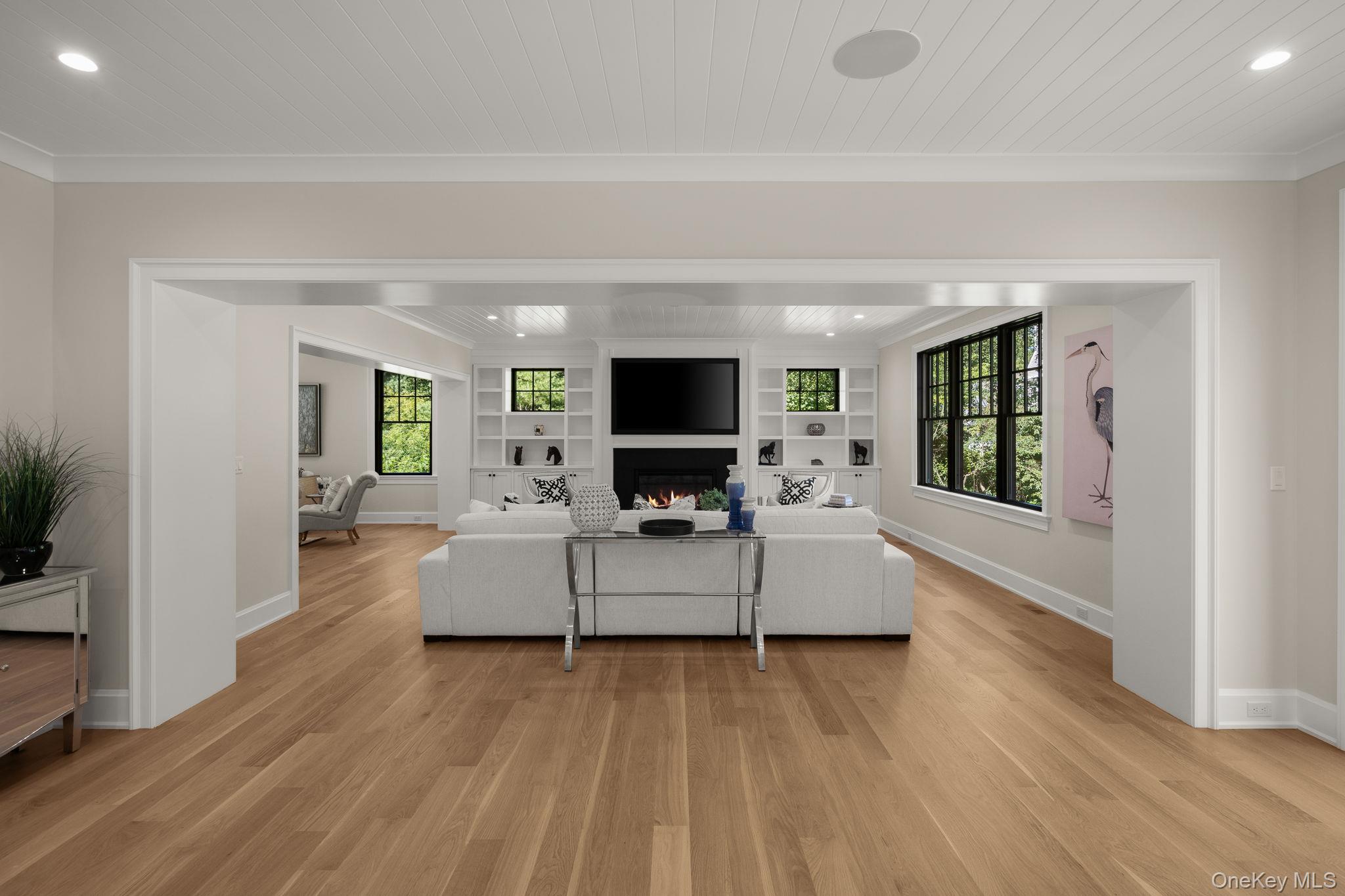 64 Saw Mill Road Cold Spring Harbor, NY 11724 - Photo 12 of 50 a living room with furniture and a flat screen tv