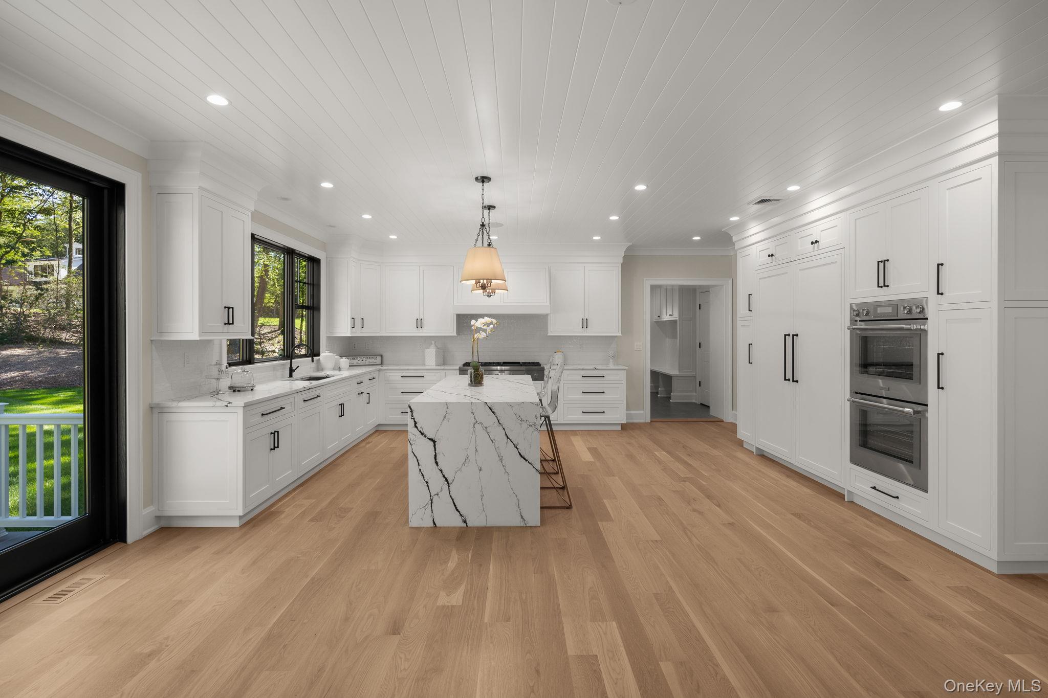 64 Saw Mill Road Cold Spring Harbor, NY 11724 - Photo 14 of 50 a large white kitchen with a large window