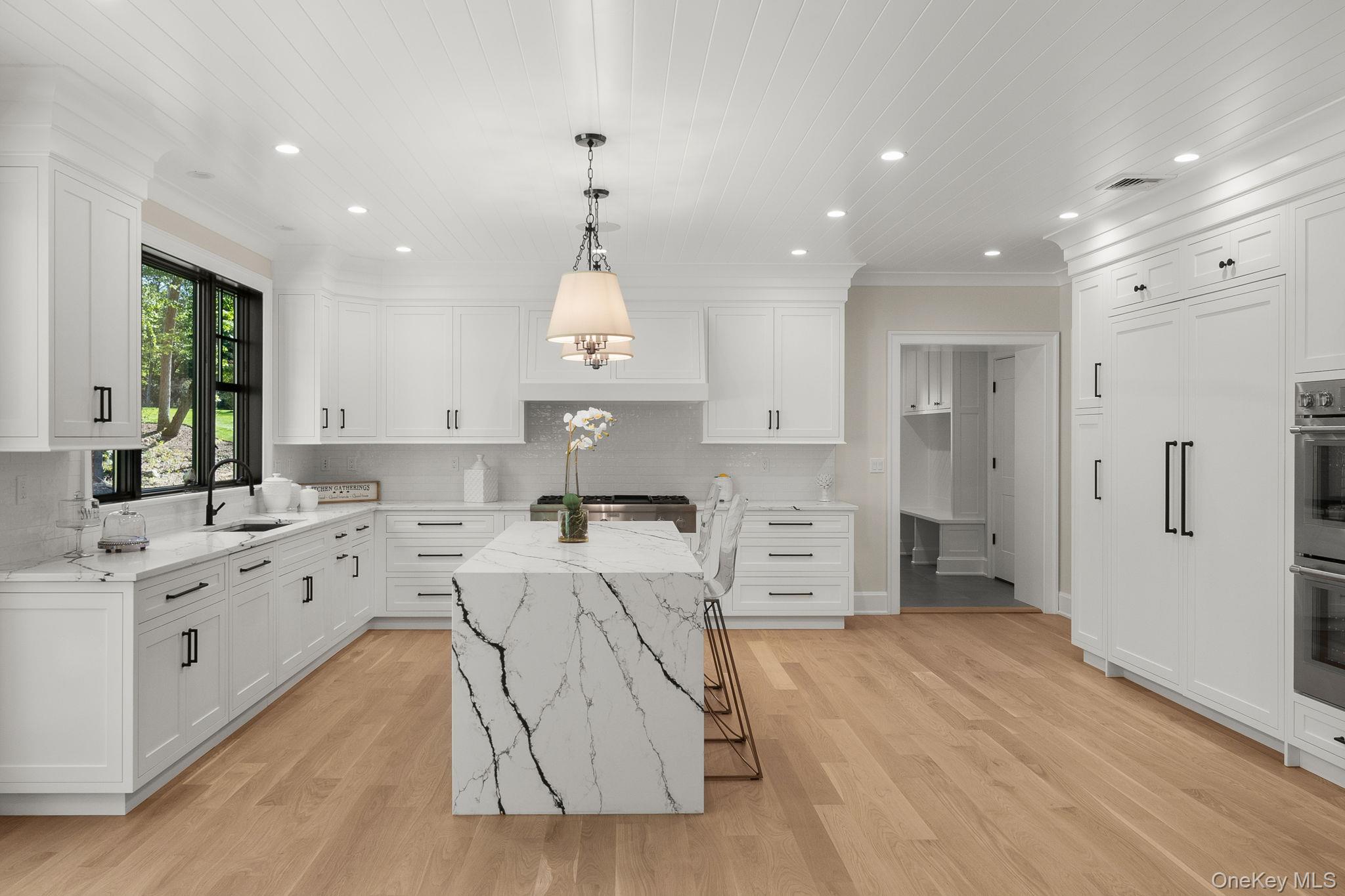 64 Saw Mill Road Cold Spring Harbor, NY 11724 - Photo 15 of 50 a large kitchen with stainless steel appliances kitchen island granite countertop a sink a stove a refrigerator and cabinets