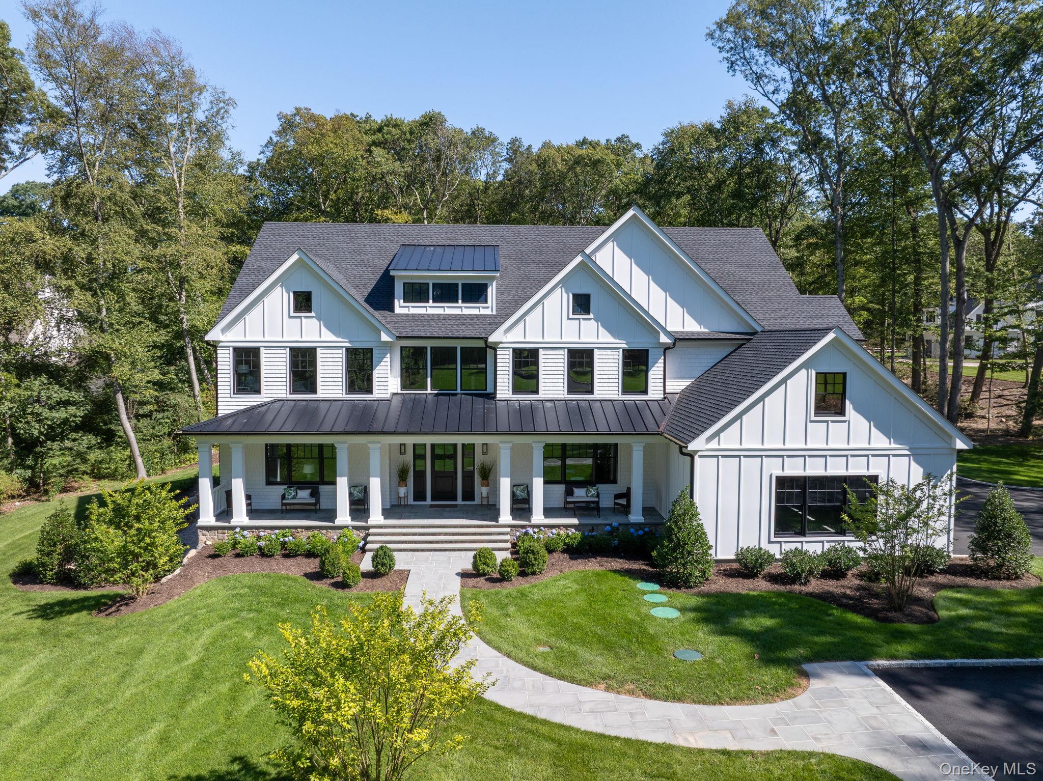 64 Saw Mill Road Cold Spring Harbor, NY 11724 - Photo 2 of 50 a front view of a residential houses with yard and green space