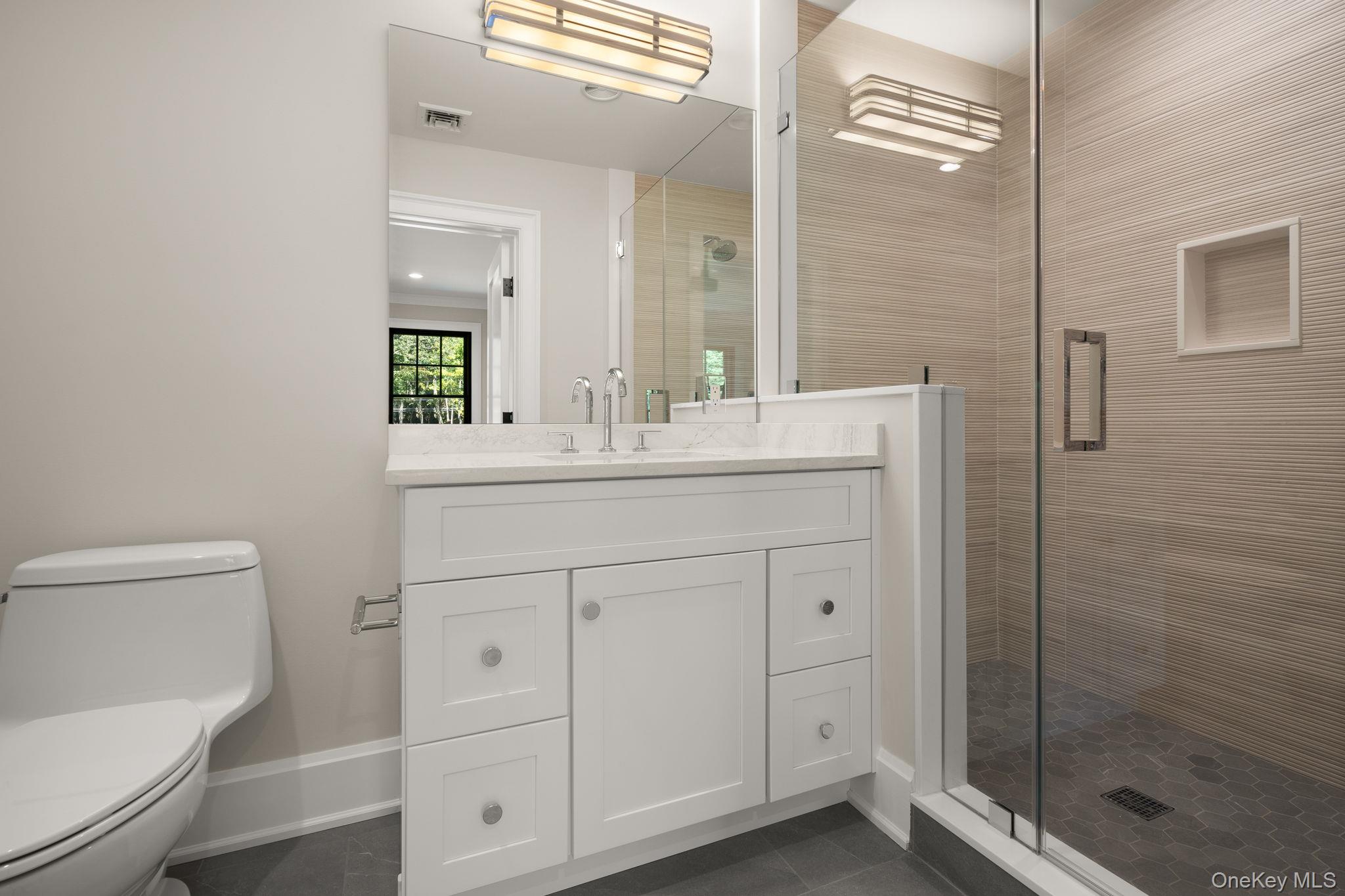 64 Saw Mill Road Cold Spring Harbor, NY 11724 - Photo 28 of 50 a bathroom with a sink a toilet and shower