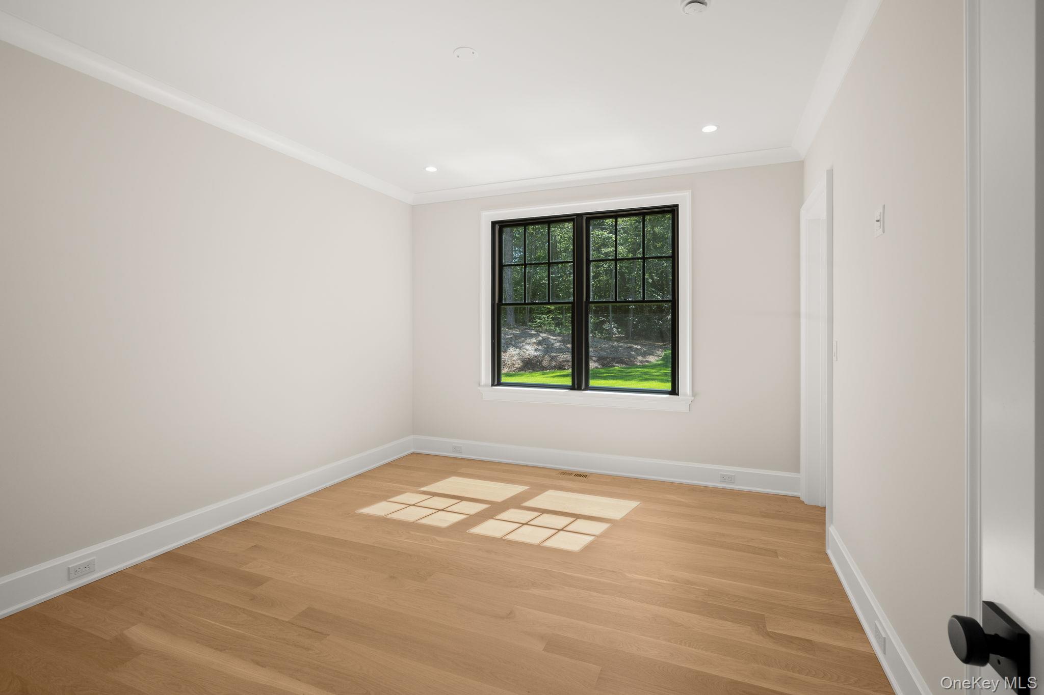 64 Saw Mill Road Cold Spring Harbor, NY 11724 - Photo 33 of 50 an empty room with wooden floor and windows