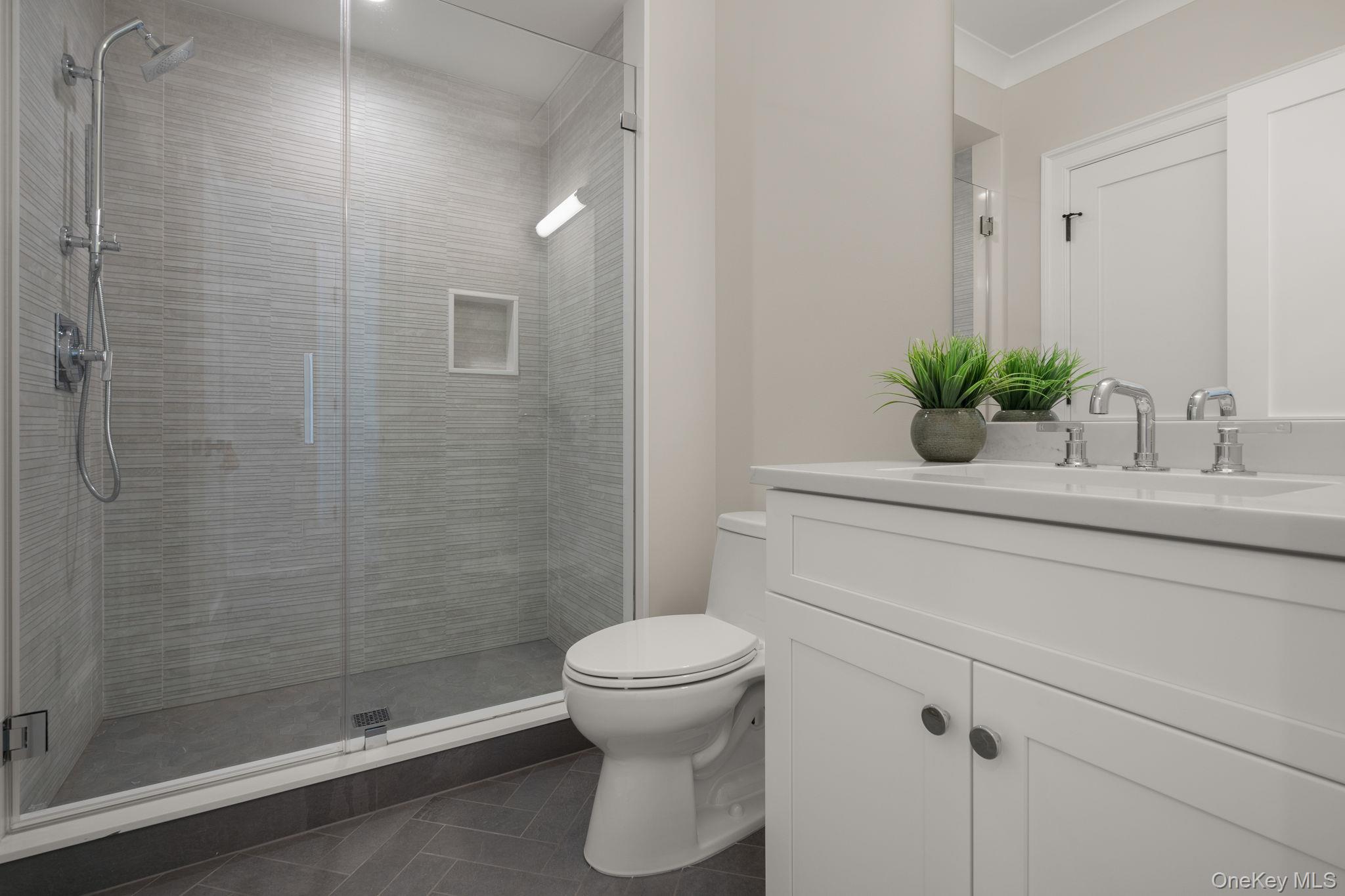 64 Saw Mill Road Cold Spring Harbor, NY 11724 - Photo 34 of 50 a bathroom with a sink a toilet and shower