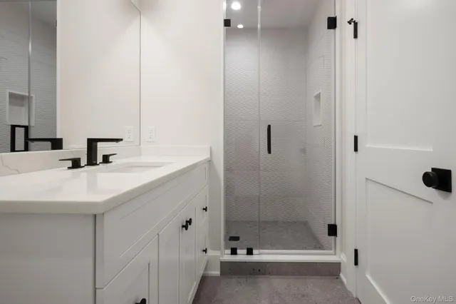 a bathroom with a shower and a sink