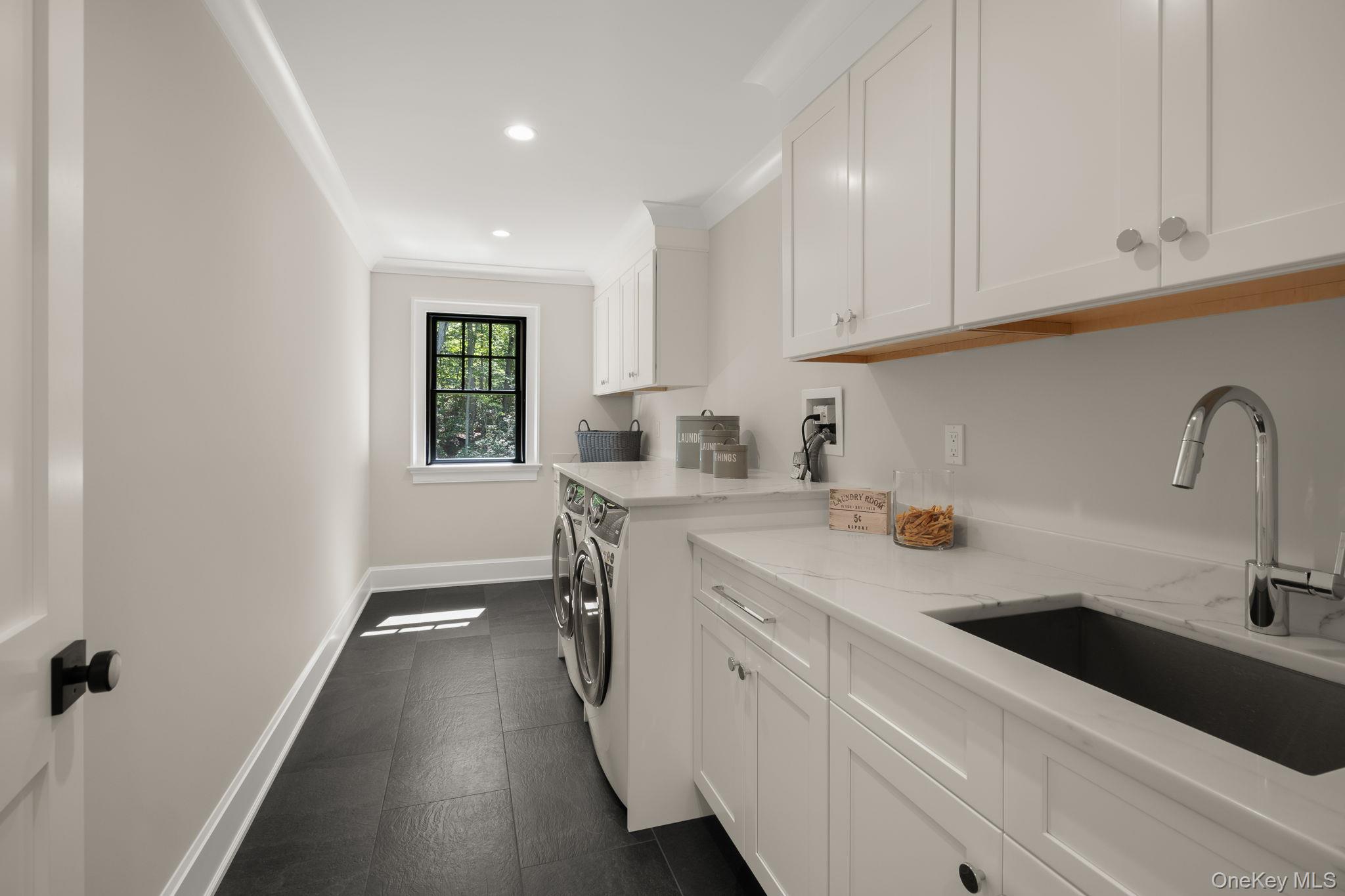 64 Saw Mill Road Cold Spring Harbor, NY 11724 - Photo 37 of 50 a kitchen with sink cabinets and window
