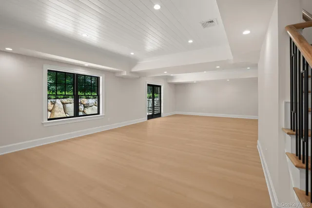 an empty room with windows and mountain view