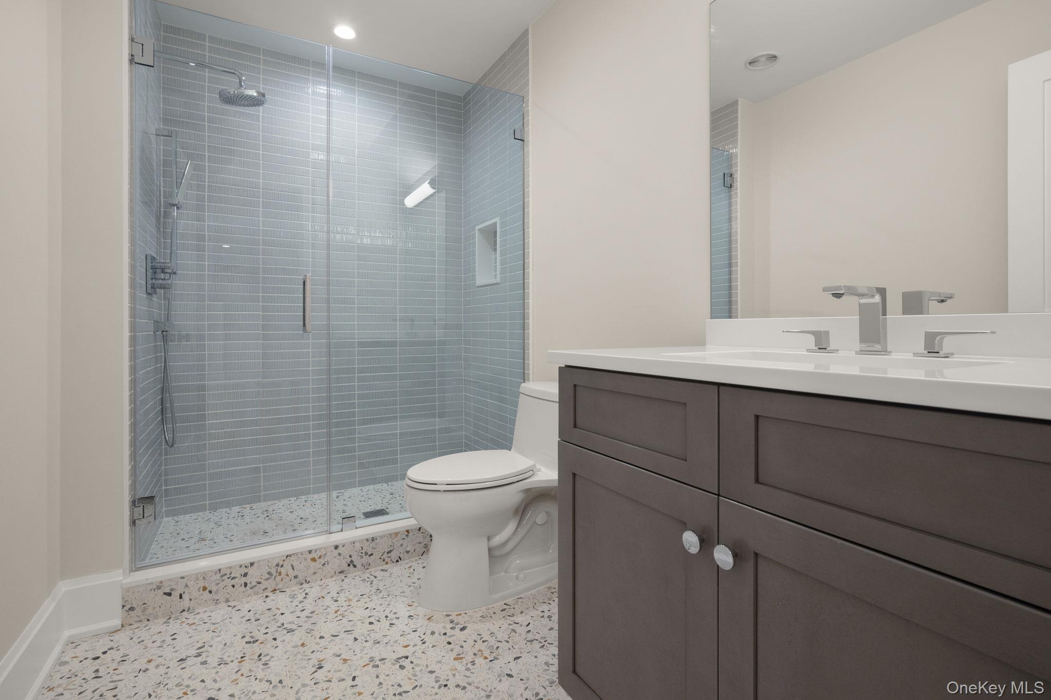 64 Saw Mill Road Cold Spring Harbor, NY 11724 - Photo 41 of 50 a bathroom with a sink a toilet and shower