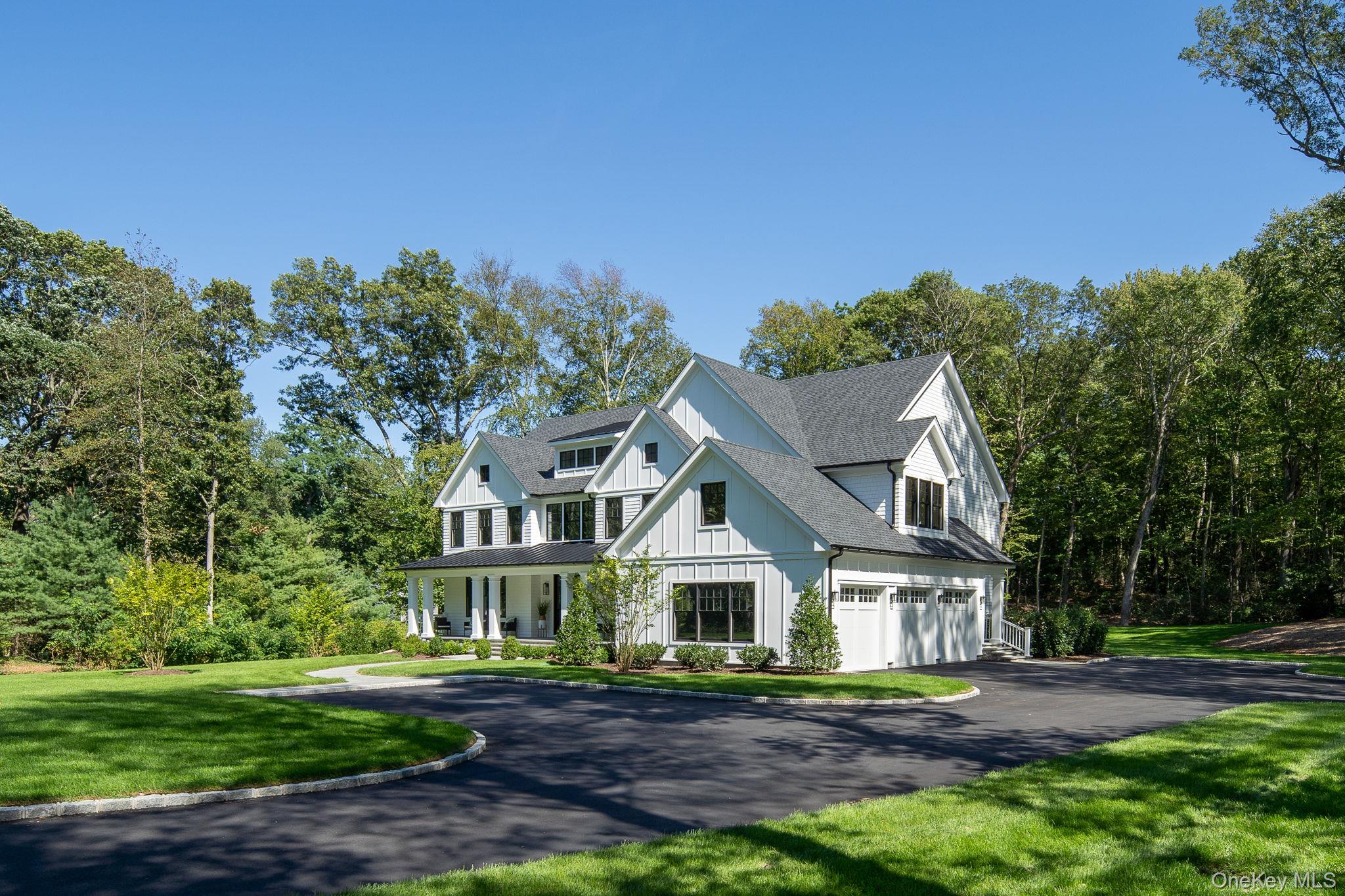 64 Saw Mill Road Cold Spring Harbor, NY 11724 - Photo 46 of 50 a front view of a house with a garden