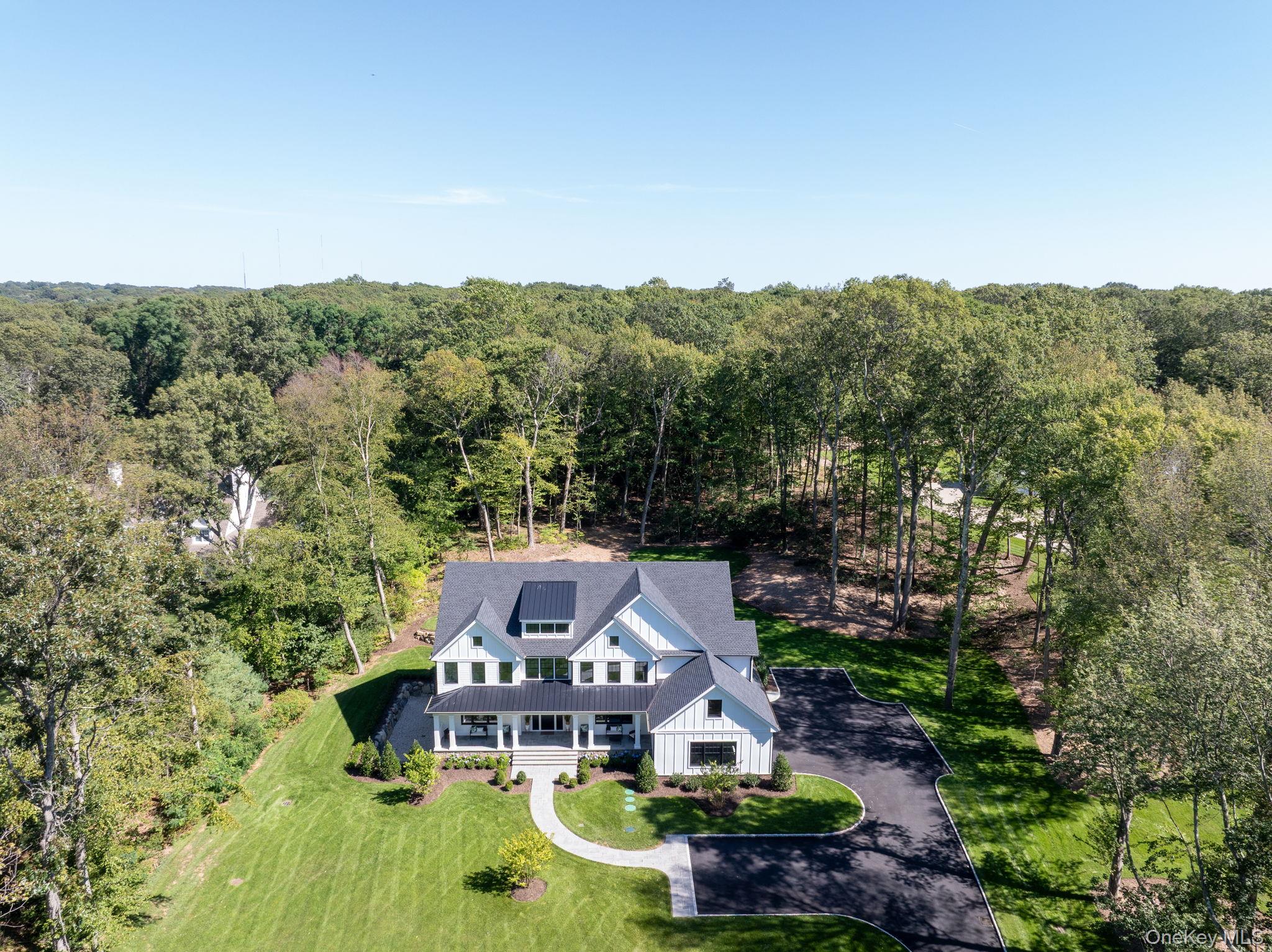 64 Saw Mill Road Cold Spring Harbor, NY 11724 - Photo 49 of 50 an aerial view of a house with swimming pool and green space