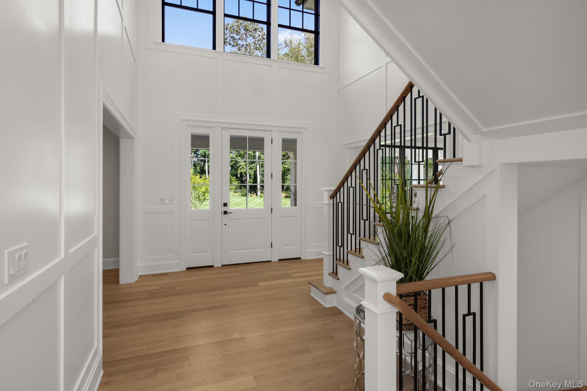 64 Saw Mill Road Cold Spring Harbor, NY 11724 - Photo 6 of 50 a view of entryway with wooden floor and stairs