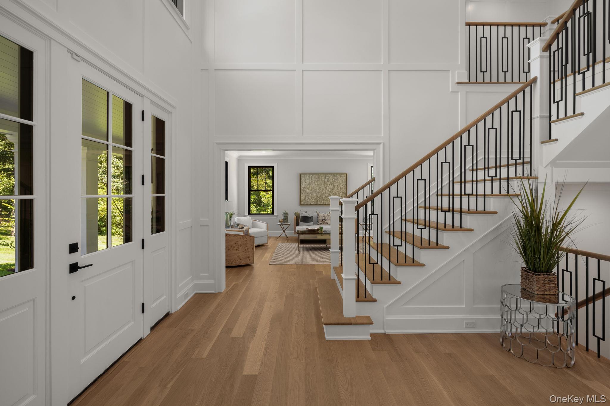 64 Saw Mill Road Cold Spring Harbor, NY 11724 - Photo 8 of 50 a view of entryway with wooden floor and front door