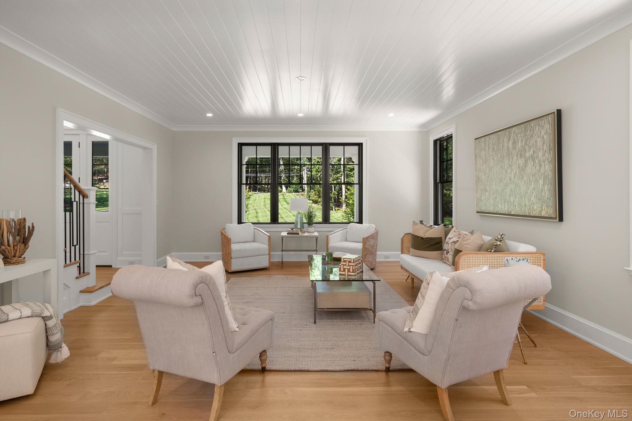 64 Saw Mill Road Cold Spring Harbor, NY 11724 - Photo 9 of 50 a living room with furniture and a large window