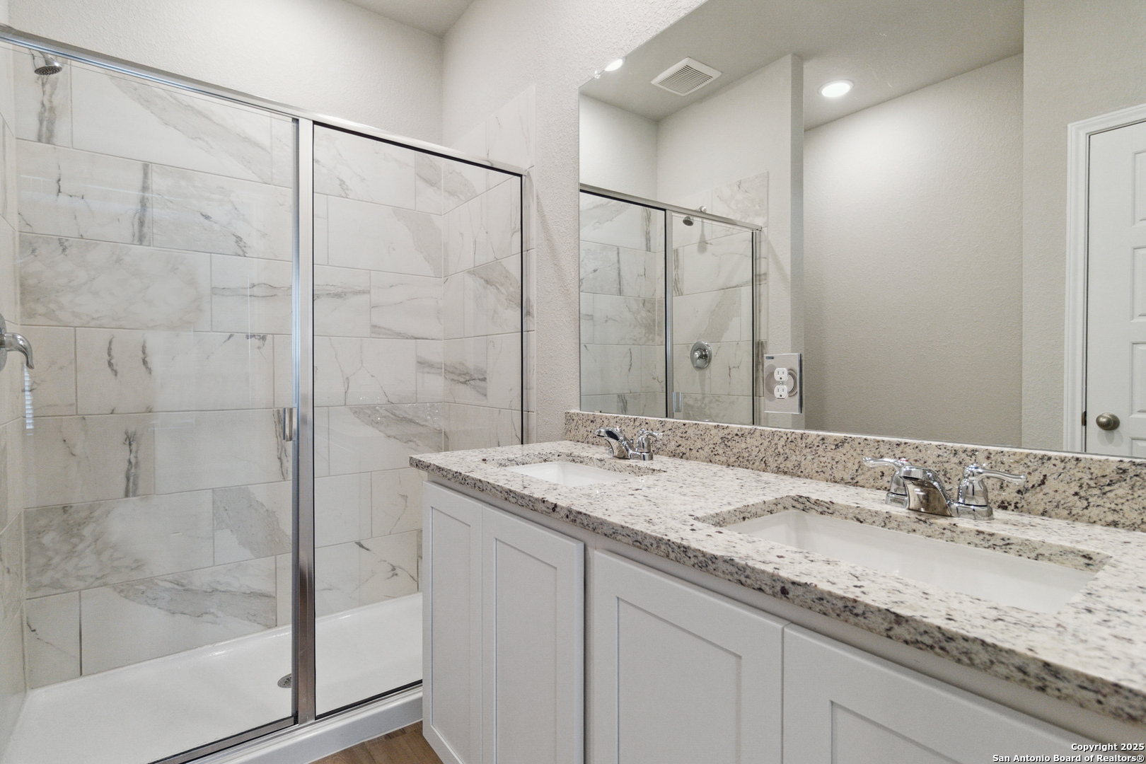 119 Gunner Road Buda, TX 78610 - Photo 19 of 30 a bathroom with a granite countertop sink a mirror and shower